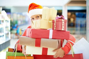 Young woman with heap of Christmas presents