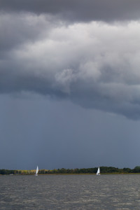 Lake landscape at storm photographed from yacht. Landscape with yachts on lake. Mazury lake district.